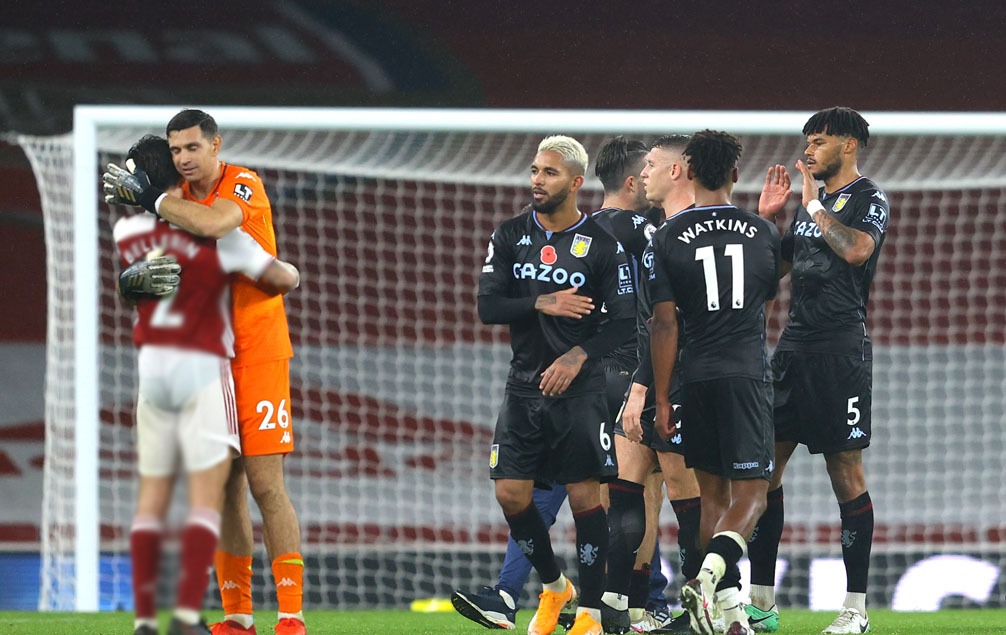 Martinez consoles his former Arsenal teammate as Villa celebrate.